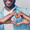 black man making shape of heart with his hands