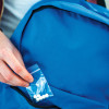 Hand putting bag of pills into pocket