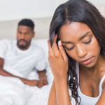 couple in bedroom pensive