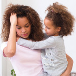 stressed mother and two childern in kitchen