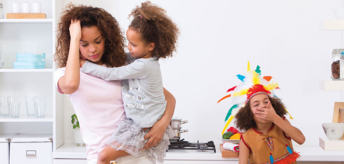 stressed mother and two childern in kitchen