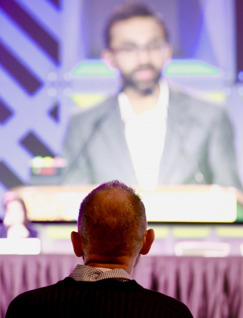 Timothy Ray Brown, aka the Berlin Patient, watches as Ravindra K. Gupta presents findings about a new case of likely cure of HIV at CROI 2019.