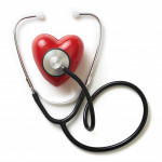 A stethoscope on a red plastic heart