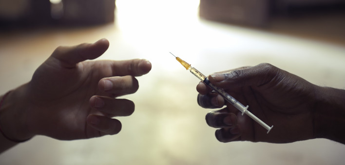 drug users passing a syringe