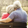 man and woman on park bench consoling