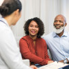 man and woman talking to a doctor