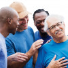 group of men supporting one man smiling