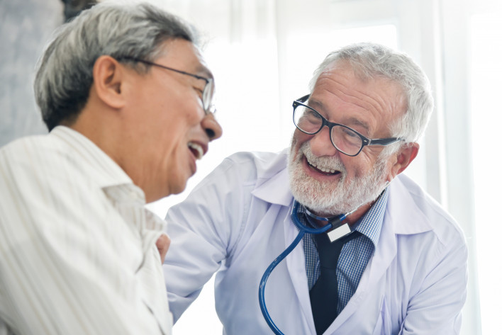 Happiness of Senior male Doctor with Asian male patient