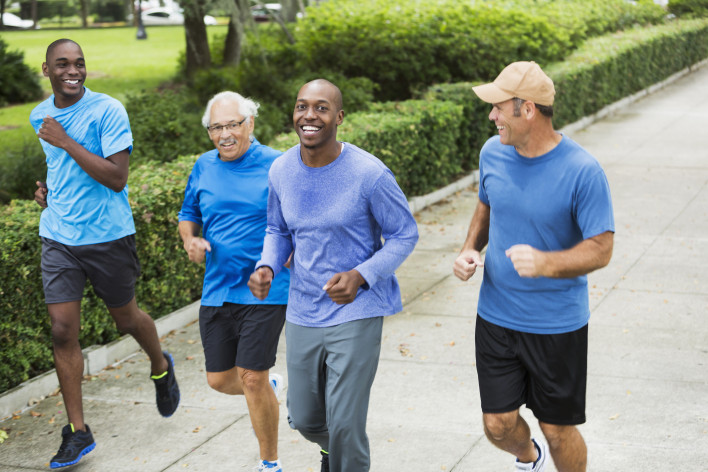 Four multiracial men jogging in park - Stock image Men, Only Men, Running, Multi-Ethnic Group, Exercising