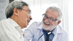 Happiness of Senior male Doctor with Asian male patient