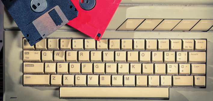 old computer keyboard and floppy disks