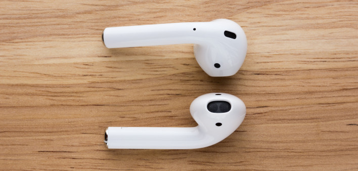 The airpods headset lies on a wooden table