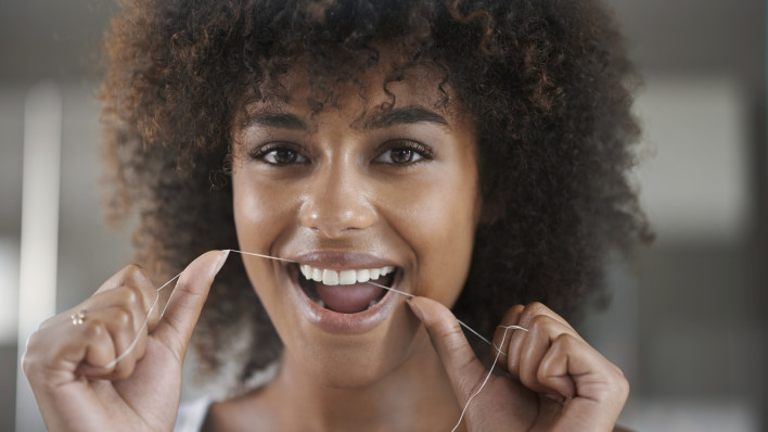woman flossing teeth