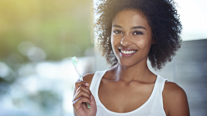 Woman holding toothbrush