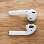 The airpods headset lies on a wooden table