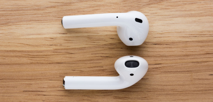The airpods headset lies on a wooden table