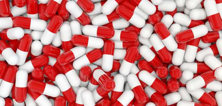 A pile of red and white capsules