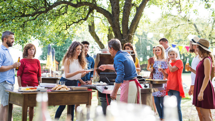 latino family having a barbecue grilling