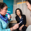 Deanna Saltzman (left) tests her lung function as Guang-Shing Cheng, MD (center), and Lisa Chung look on.