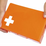 Hands of young woman holding first aid kit