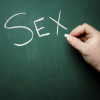 "SEX" being written on a blackboard