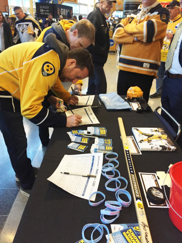 National Predators hockey fans at a Fans for Cure table.