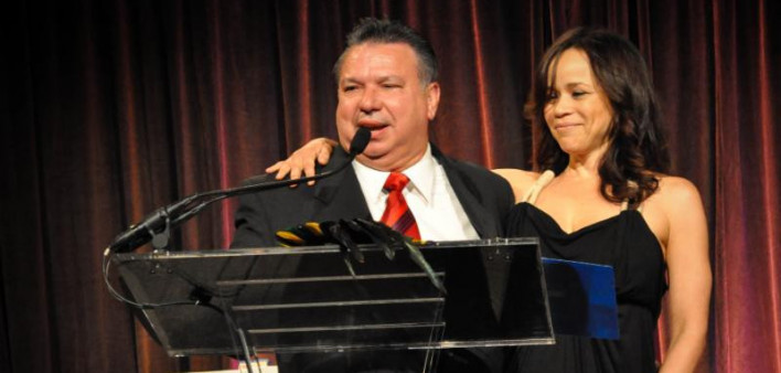 Humberto Cruz receives an award from the Latino Commission on AIDS in 2011, presented by actress Rosie Perez
