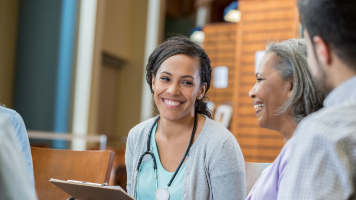 Healthcare professional talks with patients