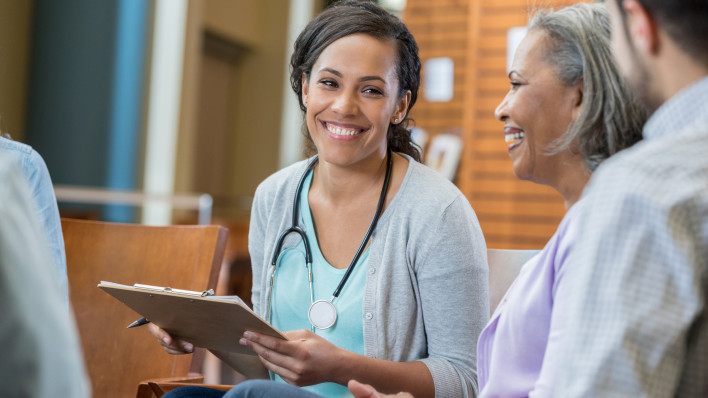 Healthcare professional talks with patients