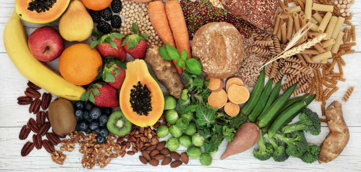 food with high fiber content for a healthy diet with fruit, vegetables, whole wheat bread, pasta, nuts, legumes, grains and cereals
