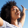 woman outside arms stretched happy