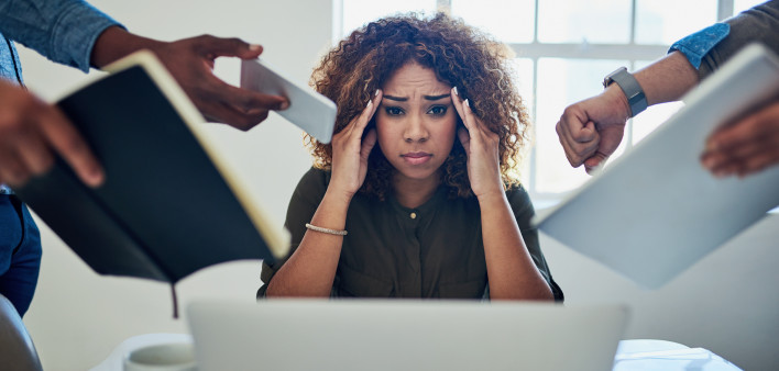 Shot of a stressed out young woman working in a demanding career