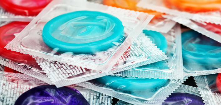 pile of mulit color condoms in clear plastic wrapers