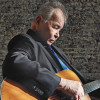 John Prine playing the guitar
