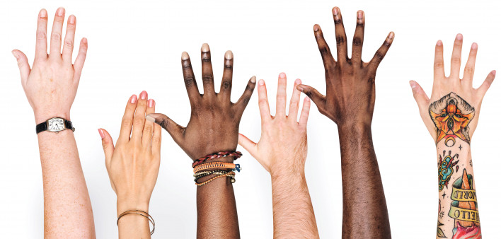 different race hands reaching upward