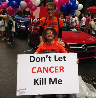 Two people hold signs at a rally for the Network
