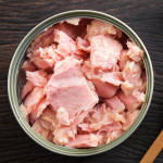 Canned soy free albacore white meat tuna packed in water on wood table background