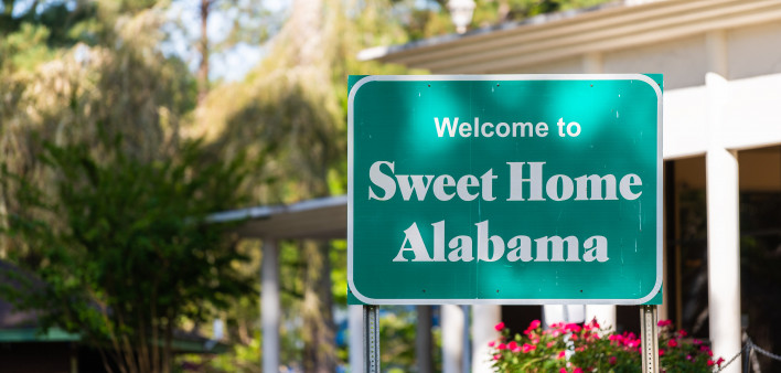 Highway road in Alabama with welcome sign on street