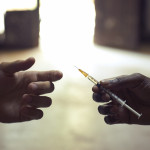 drug users passing a syringe