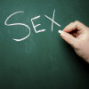 "SEX" being written on a blackboard