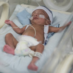 Beautiful newborn baby boy in the neonatal intensive care unit sleeping
