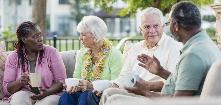 Two older couples hanging out on patio