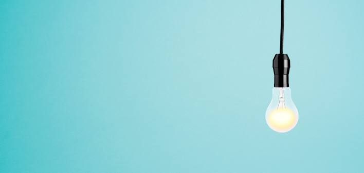 bare lit lightbuld in socket hanging