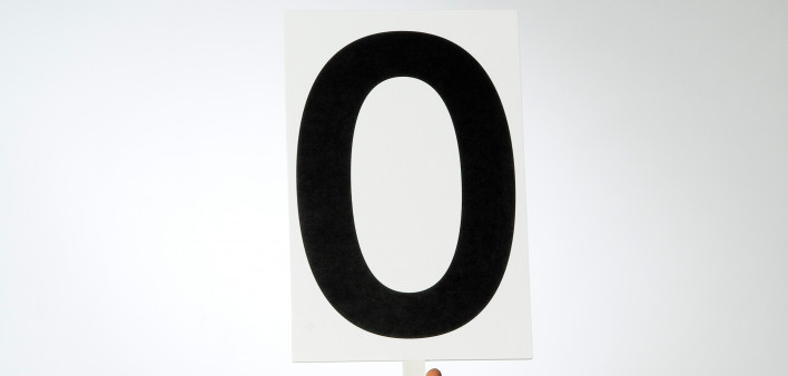 arm and hand holding up a card with zero