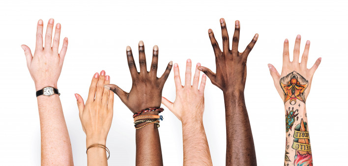 different race hands reaching upward