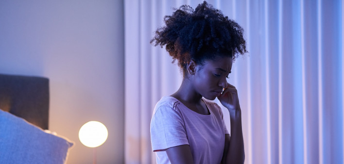 african woman in bedroom at night