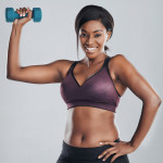 black woman in workout gear lifting a dumbell