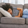 girl sick sleeping on couch