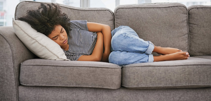 girl sick sleeping on couch