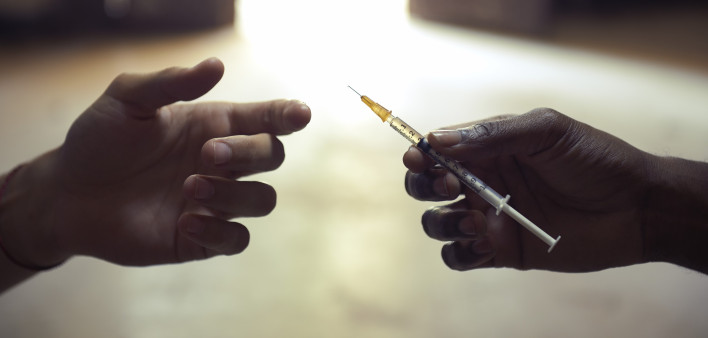 drug users passing a syringe